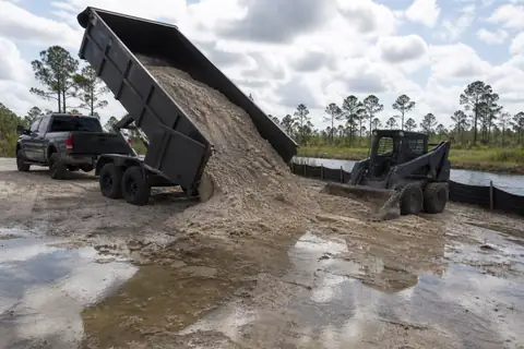 Clean sandy fill spread in controlled lifts on an inland Lee County construction site